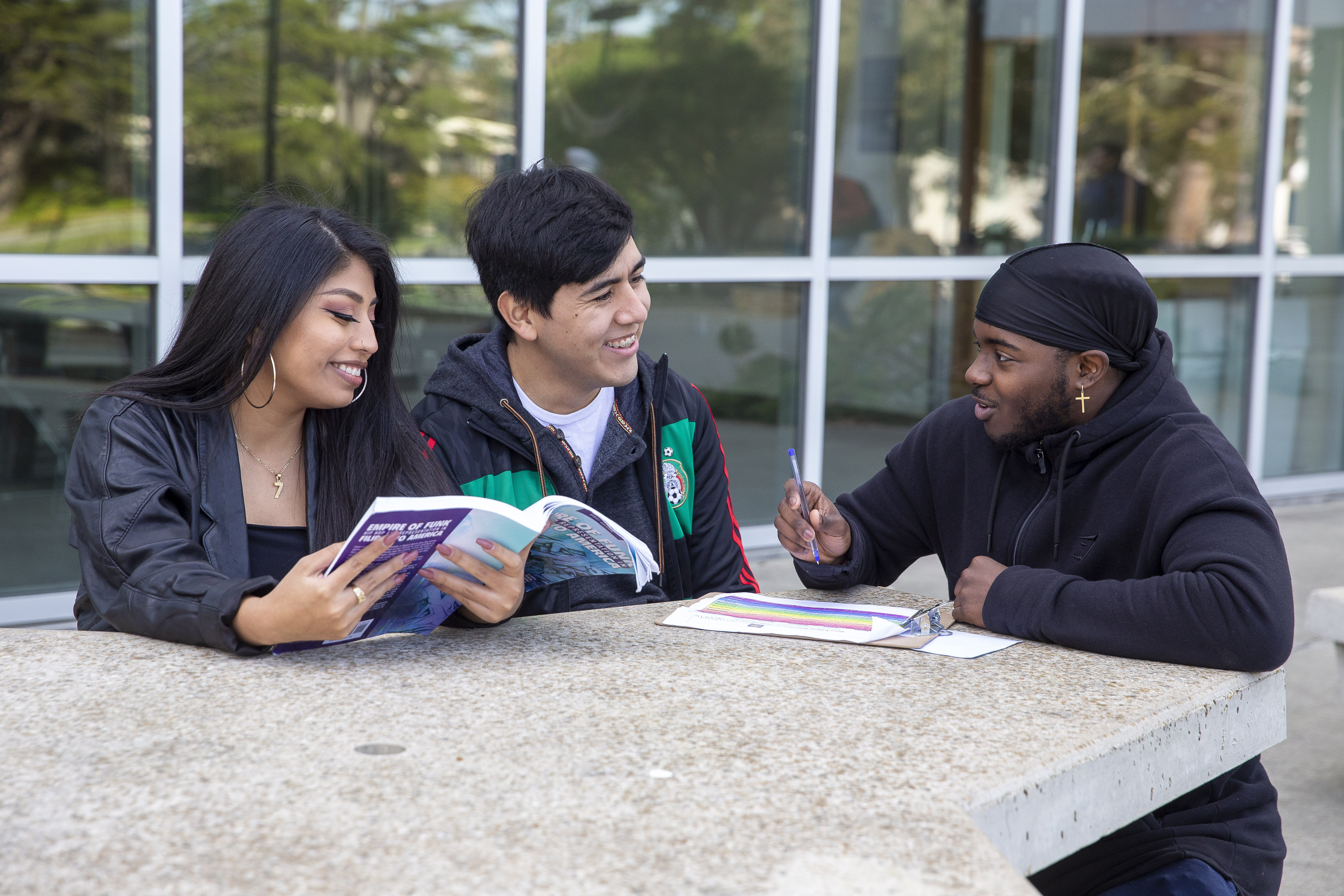 Three students studying outdoor