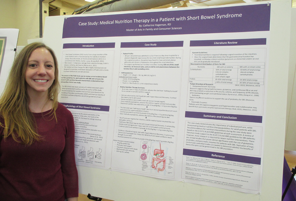 Student standing next to a display board with Information on nutrition therapy for patients with short bowel syndrome